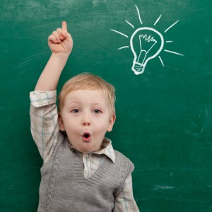 Cheerful smiling child at the blackboard. School concept